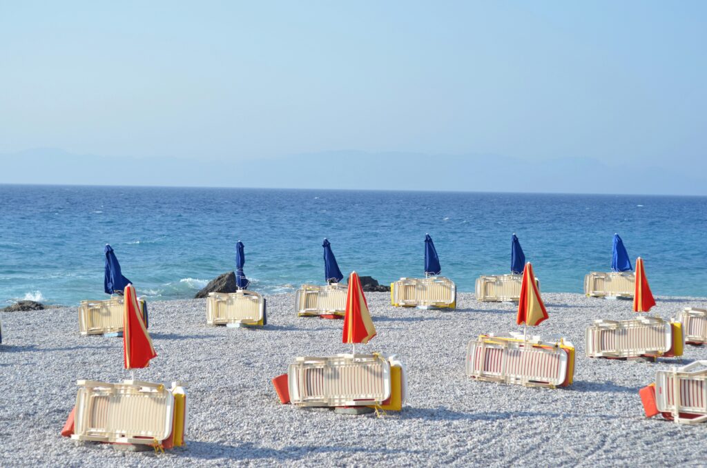 Beach chairs and umbrellas lined up in Rhodes, Greece