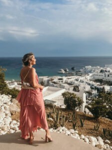 Girl looking out into the romantic greek islands of Mykonos, Greece