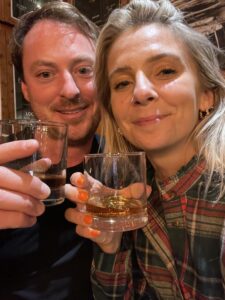 A man and a woman drinking whisky in a Scotland Tours