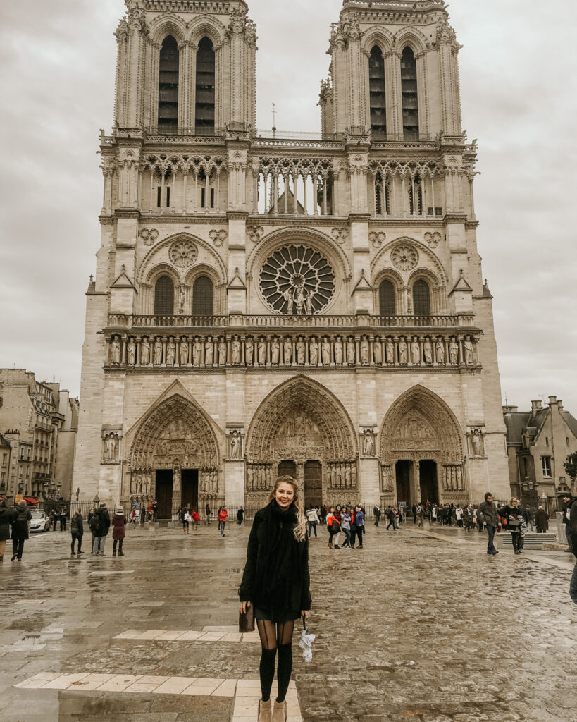 Girl standing outside Notre Dame in Paris, France