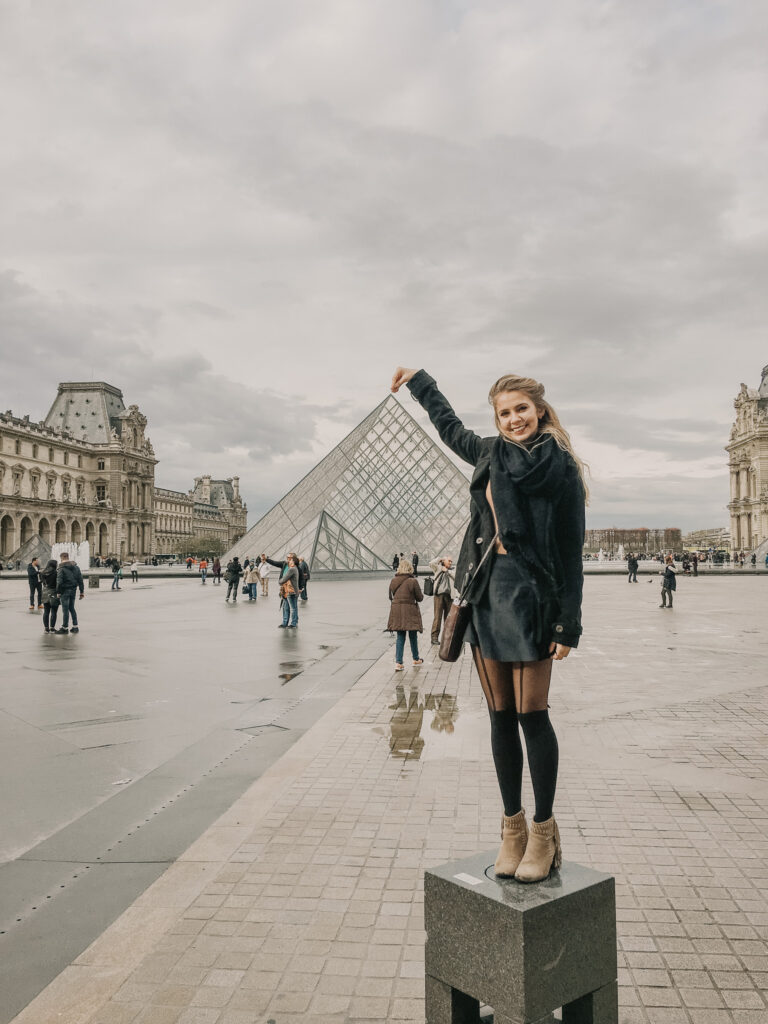 Girl standing outside the louvre in Paris, France
